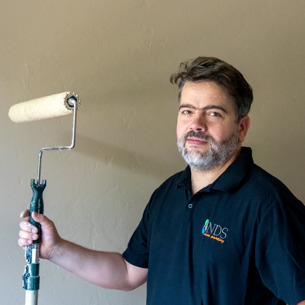 Niro DaSilva of NDS Fine Residential Painting holding a paint roller